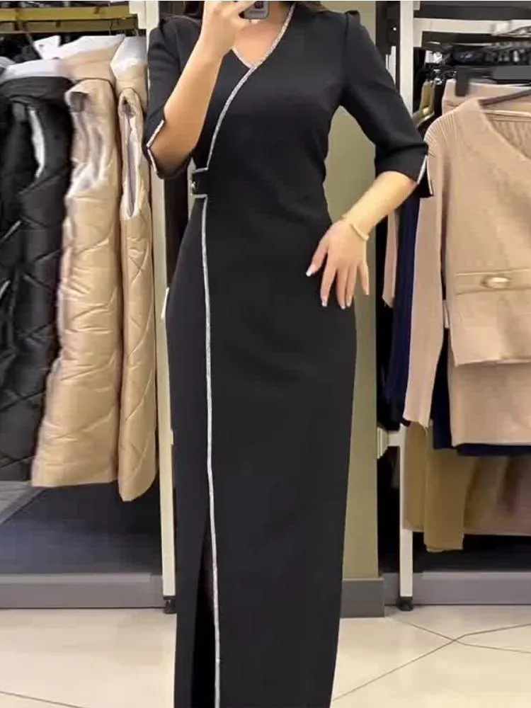 Long Black Dress with Fringe Details and Elegant Brooch